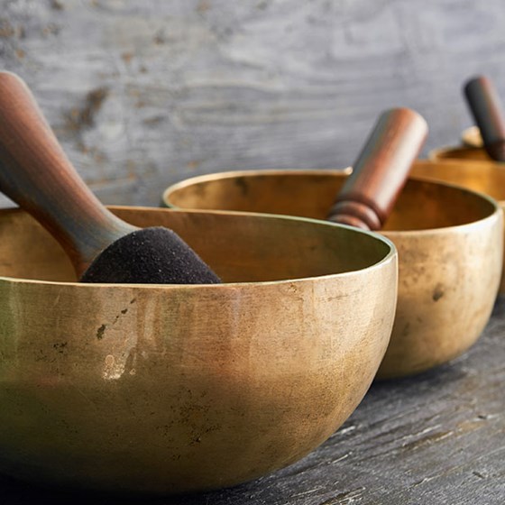 Gold sound baths lined up against wall