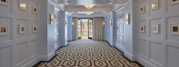 Canon event space with blue walls, pattern carpet and wide windows.