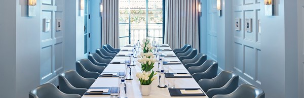 Blue chairs set around a desk in a meeting room