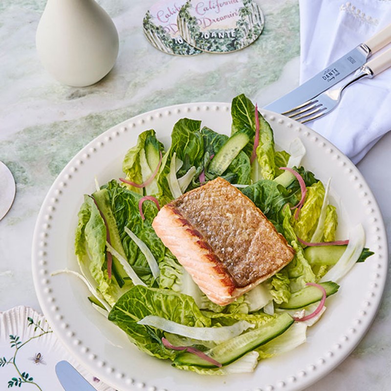 Fillet of salmon placed upon lettuce leaves
