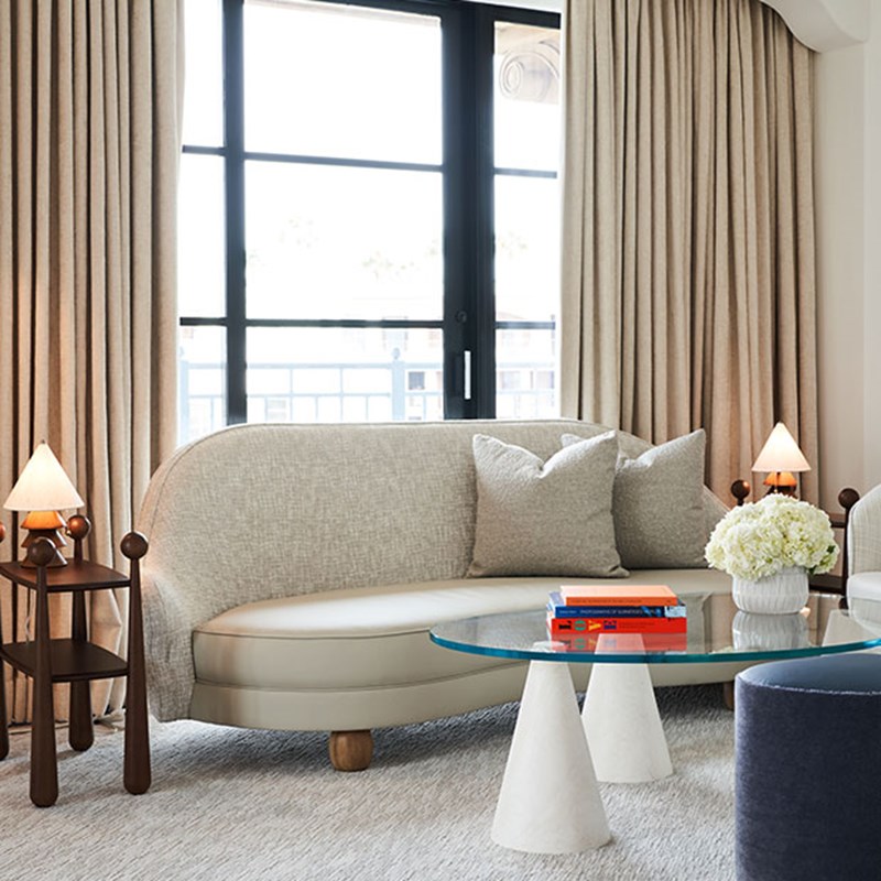 Small two-seater sofa in front of floor-to-ceiling window