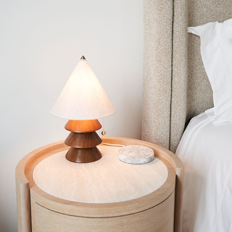 Quirky lamp on bedside table next to King bed
