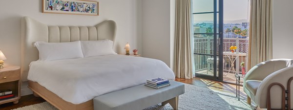 Hotel room bedroom with large bed and balcony