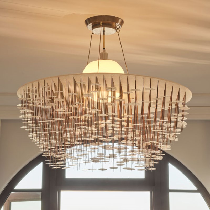 Glass chandelier hanging from the ceiling in the living area