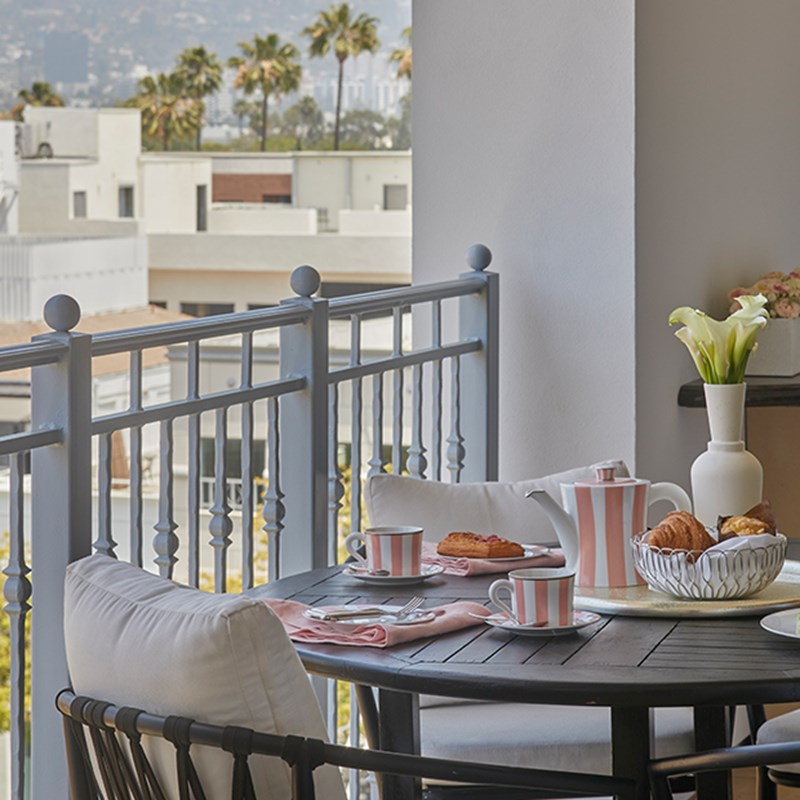 Pink and white tea set on table with background of Hollywood Hills